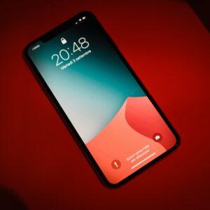 a close up of a cell phone on a red surface