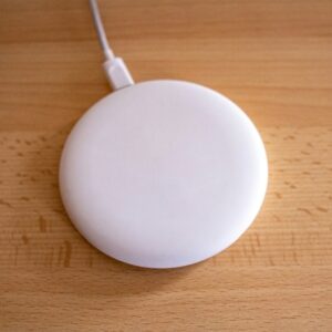 white round device on brown wooden table