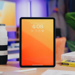 a tablet computer sitting on top of a wooden desk